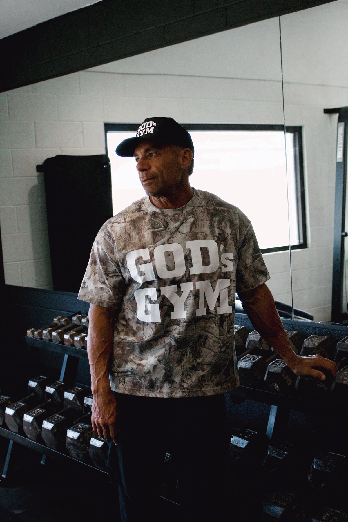 Man wearing the God's Gym Faded Camo Tee in the gym