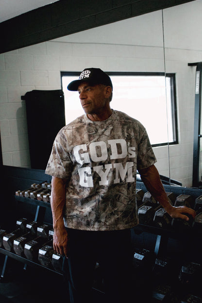 Man wearing the God's Gym Faded Camo Tee in the gym